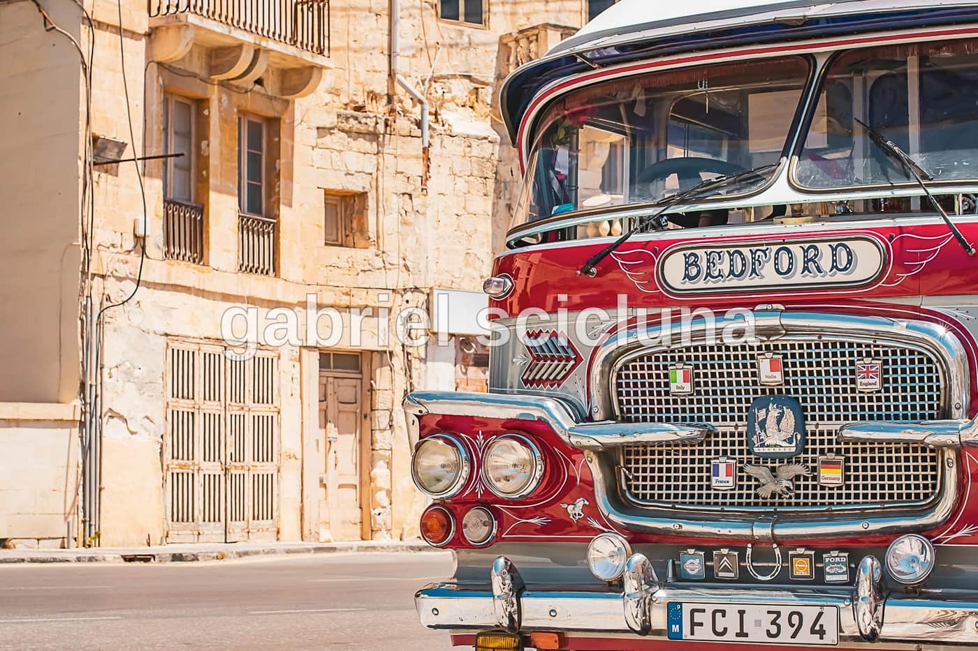 A classic Maltese bus photographed on a village street.