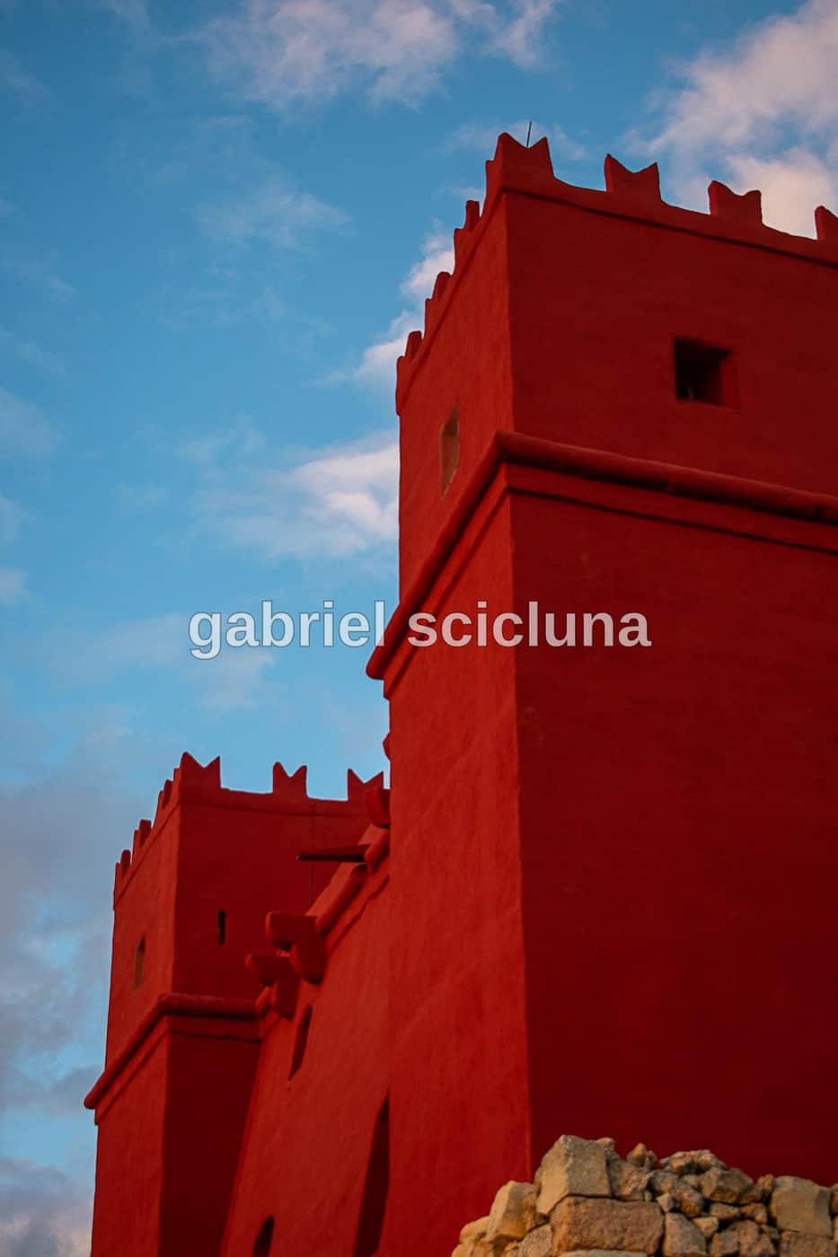 A vivid view of the Red Tower (St Agatha's Tower), a distinctive historic landmark in northern Malta.