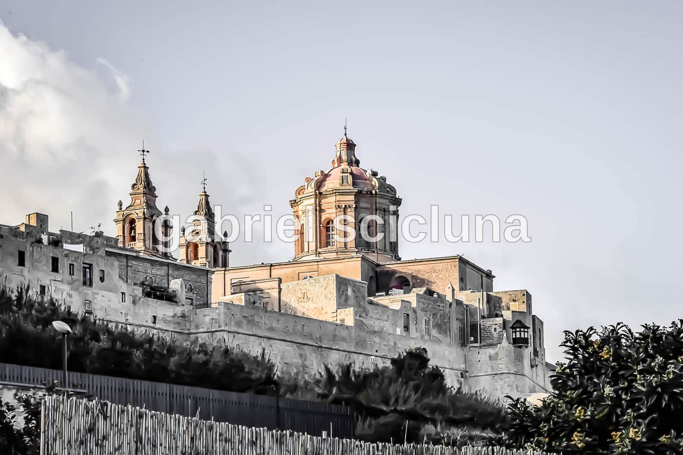 A toned study of Malta's rooftops and church architecture.